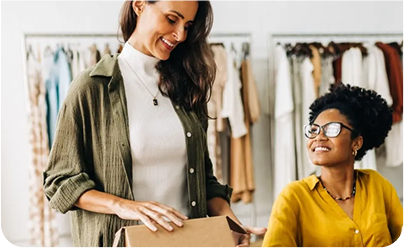 Women discussing strategy in fashion store