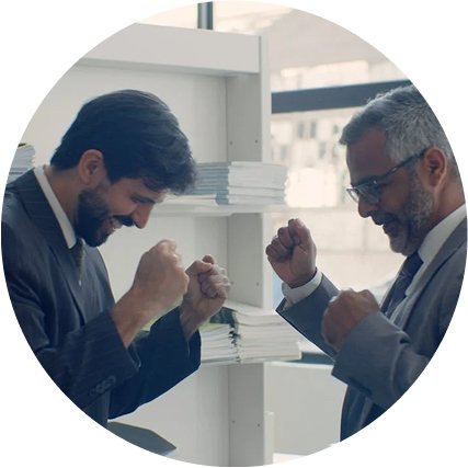 Two businessmen celebrating a successful sales automation result in an office.